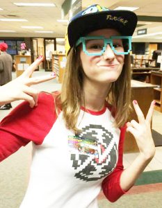 Teen dressed as Pokemon trainer posing for the camera